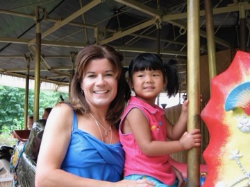 A childhood photo of Katie at a carousel.